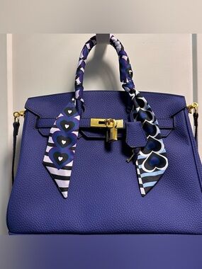 Blue leather “wirkin” crossbody Bag with Gold Hardware.